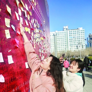 市民在运城市区南风广场祈福墙上写下新春祝福